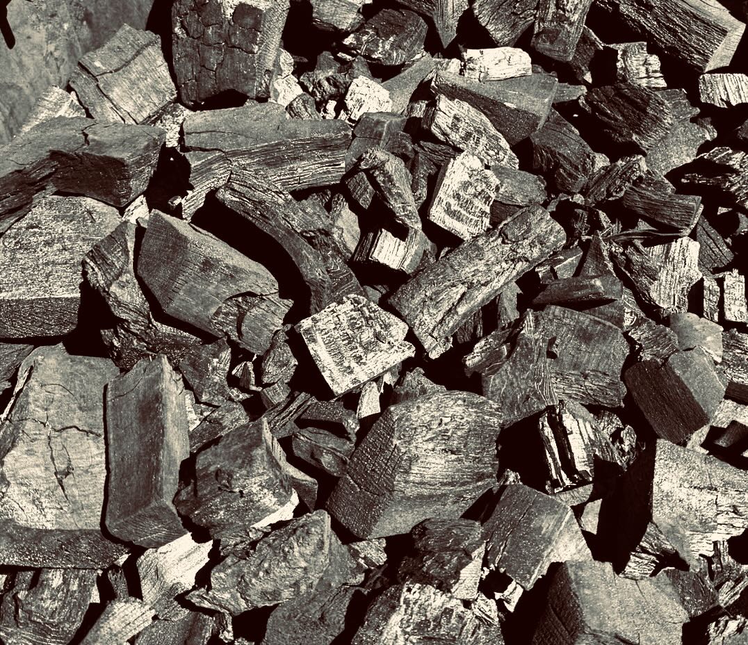 Splitting hardwood by the shed — stump, tyre and axes